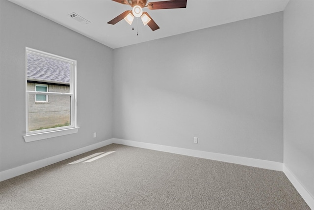 empty room featuring ceiling fan and carpet