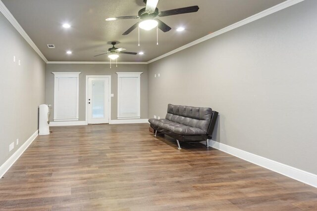 sitting room with hardwood / wood-style flooring, ornamental molding, and ceiling fan