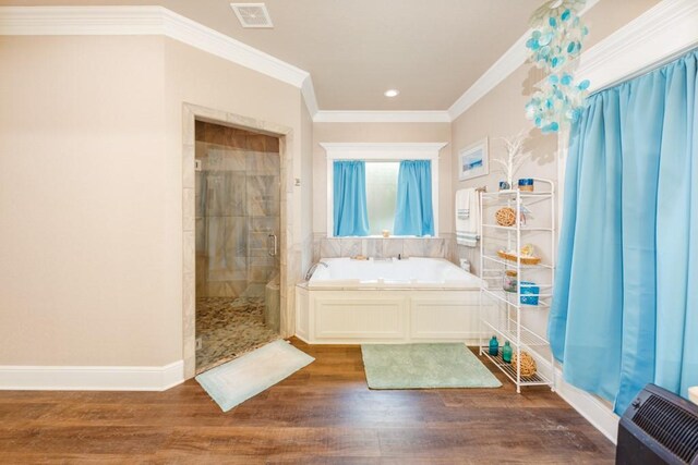 bathroom with ornamental molding, hardwood / wood-style floors, and plus walk in shower