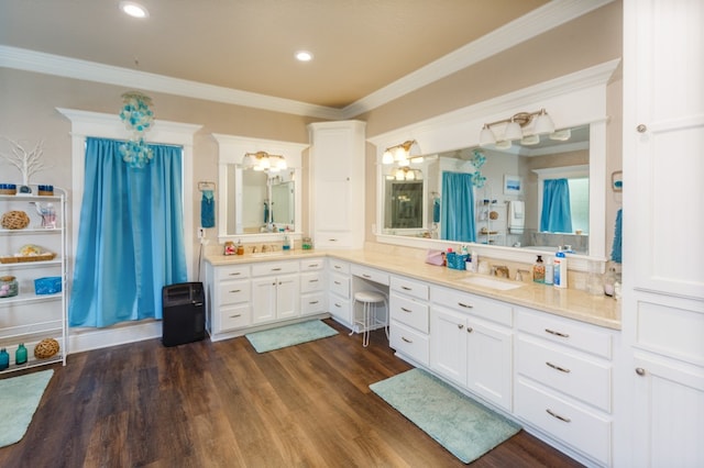 bathroom featuring ornamental molding, vanity, and hardwood / wood-style flooring