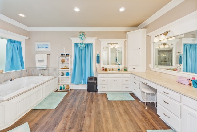 bathroom with vanity, wood-type flooring, a washtub, and crown molding