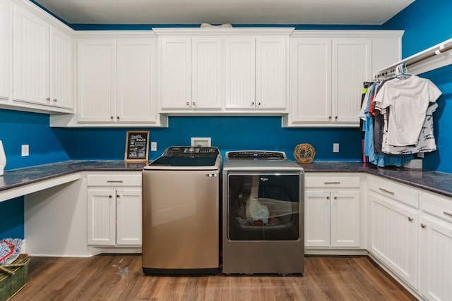 laundry room with dark hardwood / wood-style flooring, cabinets, and washer and dryer