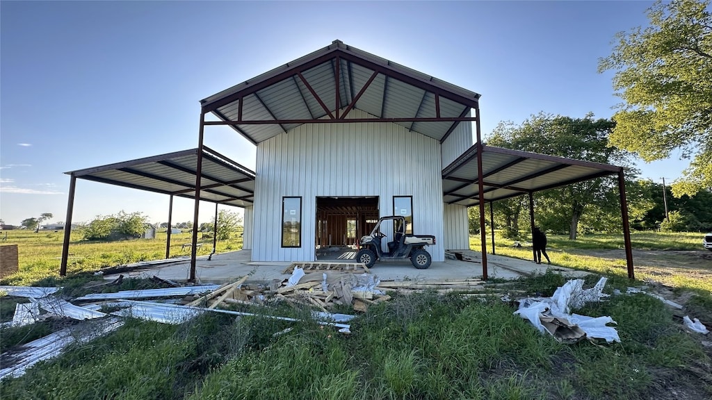 back of house featuring a carport