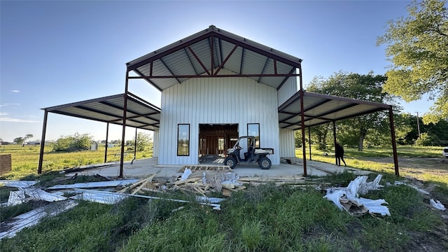 back of house featuring a carport