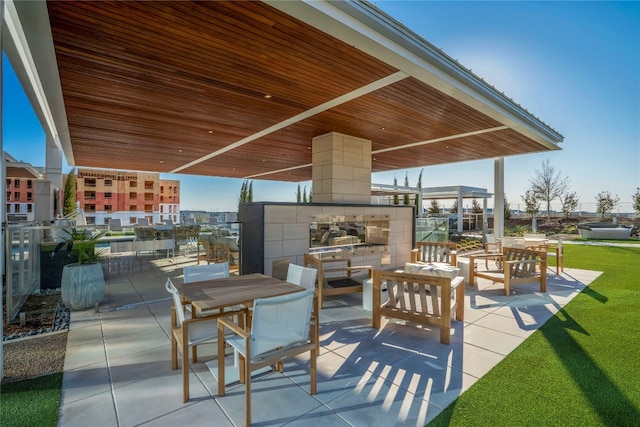 view of patio featuring an outdoor living space with a fireplace