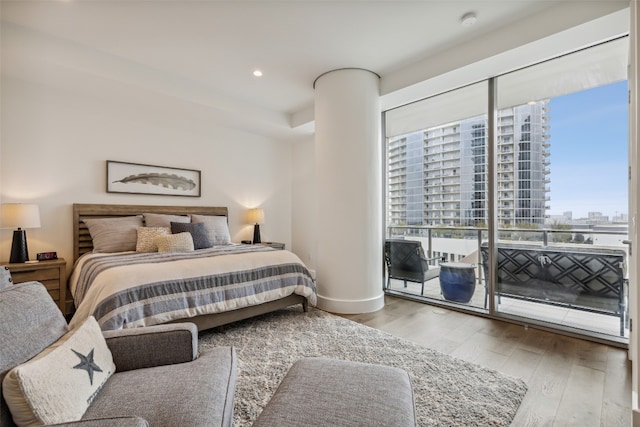 bedroom with light hardwood / wood-style flooring and access to outside