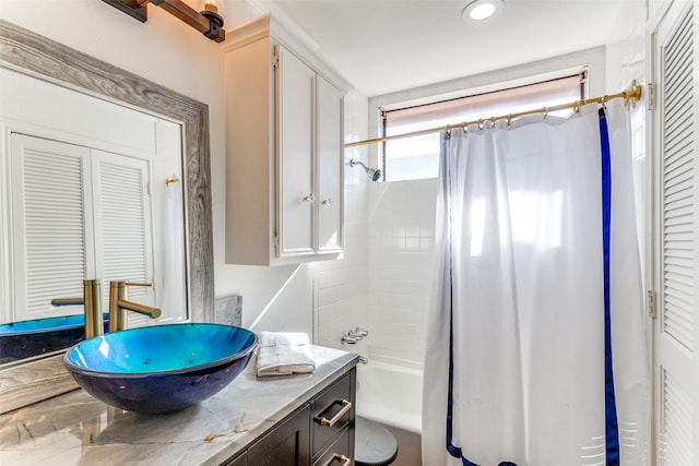 bathroom featuring shower / bath combination with curtain and vanity