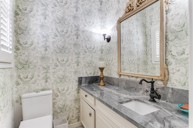 bathroom featuring vanity and toilet