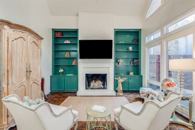 living room with a fireplace, built in features, dark wood-type flooring, and vaulted ceiling