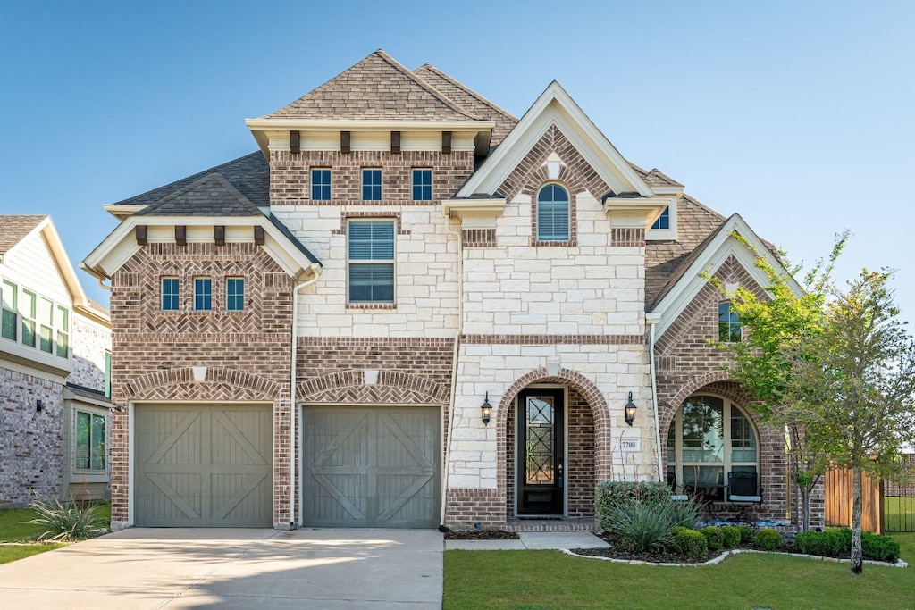 view of front facade with a front lawn and a garage