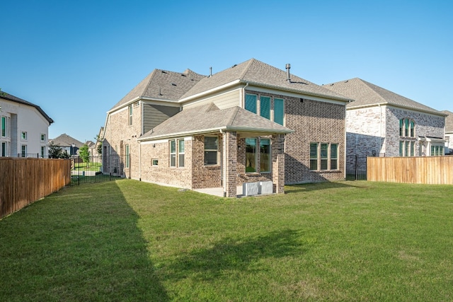 rear view of house with a lawn