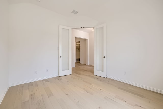 spare room featuring light hardwood / wood-style floors