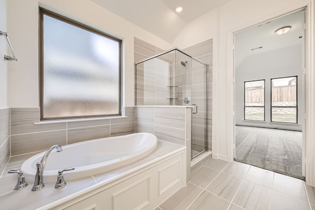 bathroom with vaulted ceiling, tile patterned floors, and separate shower and tub