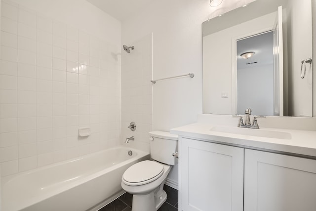 full bathroom featuring tile patterned flooring, toilet, tiled shower / bath combo, and vanity