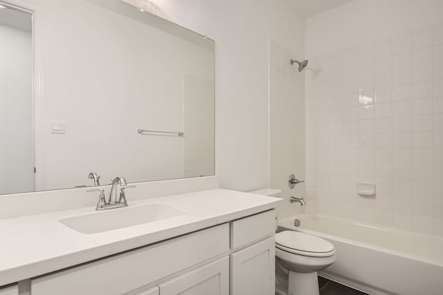 full bathroom with vanity, tiled shower / bath combo, toilet, and tile patterned floors