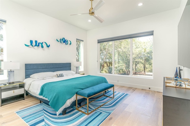 bedroom with light hardwood / wood-style flooring and ceiling fan