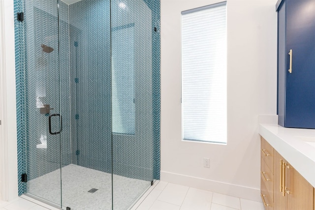 bathroom featuring a shower with shower door, vanity, and tile floors