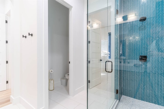 bathroom featuring an enclosed shower, toilet, and tile flooring