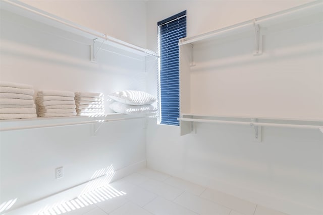 spacious closet with light tile floors