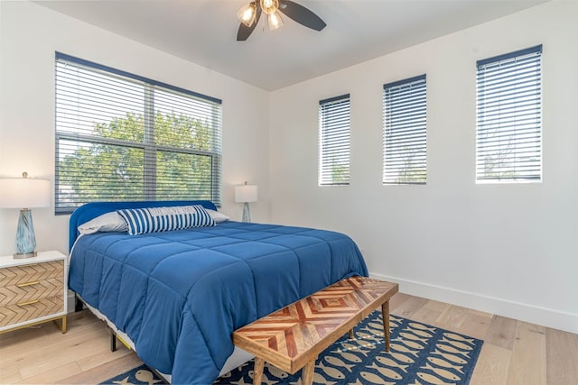 bedroom with light hardwood / wood-style flooring and ceiling fan