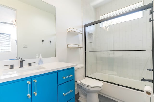 full bathroom featuring enclosed tub / shower combo, toilet, ceiling fan, and large vanity