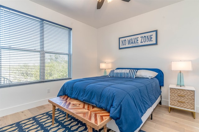 bedroom with light hardwood / wood-style floors and ceiling fan