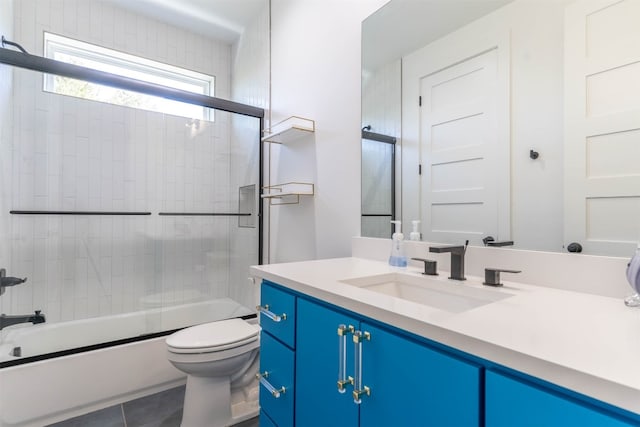 full bathroom with enclosed tub / shower combo, toilet, tile floors, and vanity