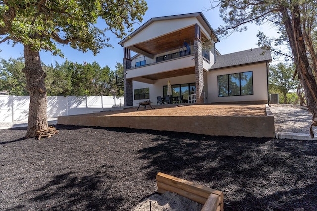 back of house featuring a patio, a balcony, and central AC unit