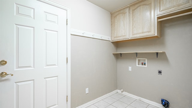 clothes washing area with light tile patterned floors, electric dryer hookup, washer hookup, and cabinets