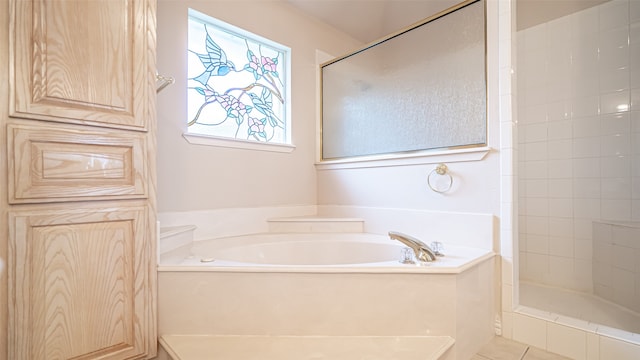 bathroom with separate shower and tub and tile patterned flooring