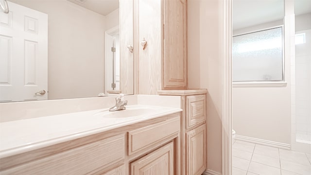 bathroom with tile patterned flooring, vanity, and toilet