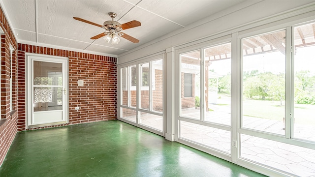 unfurnished sunroom with ceiling fan and a wealth of natural light