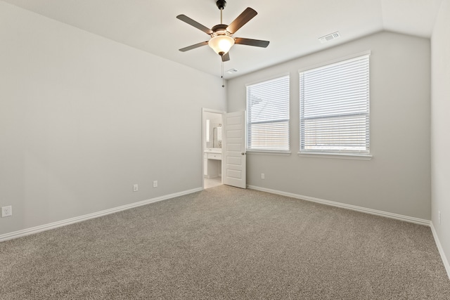 spare room featuring vaulted ceiling, ceiling fan, and light colored carpet