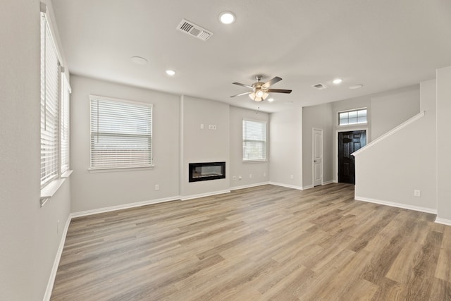 unfurnished living room with ceiling fan and light hardwood / wood-style floors