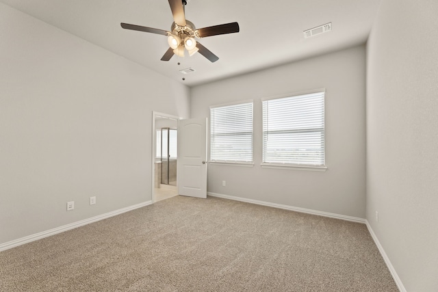 carpeted empty room featuring ceiling fan