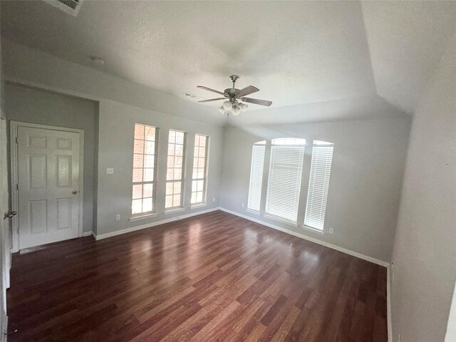 spare room with dark wood-type flooring and ceiling fan