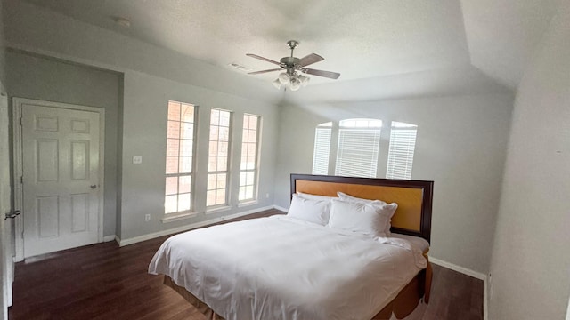 bedroom with dark hardwood / wood-style flooring and ceiling fan