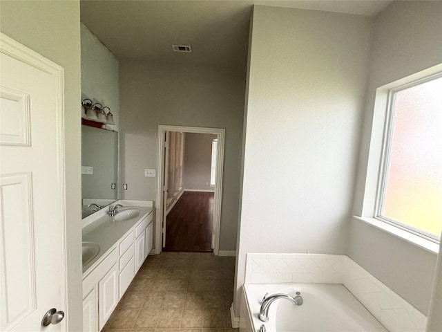 bathroom featuring vanity and a bath