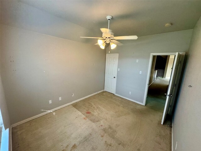 unfurnished bedroom featuring light colored carpet and ceiling fan