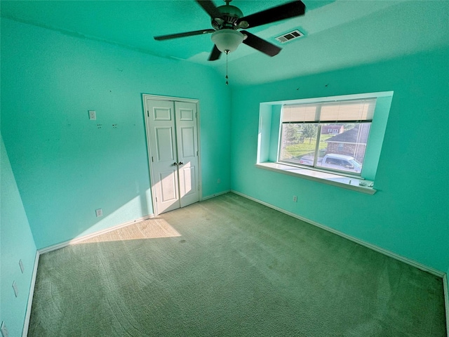 carpeted empty room featuring lofted ceiling and ceiling fan