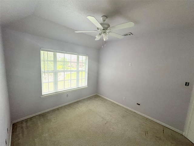 carpeted spare room with ceiling fan