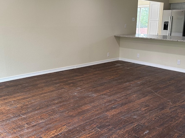 empty room featuring dark hardwood / wood-style flooring