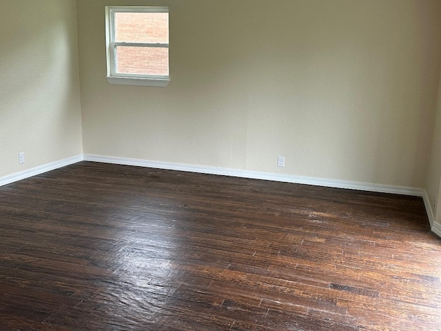 unfurnished room featuring dark wood-type flooring