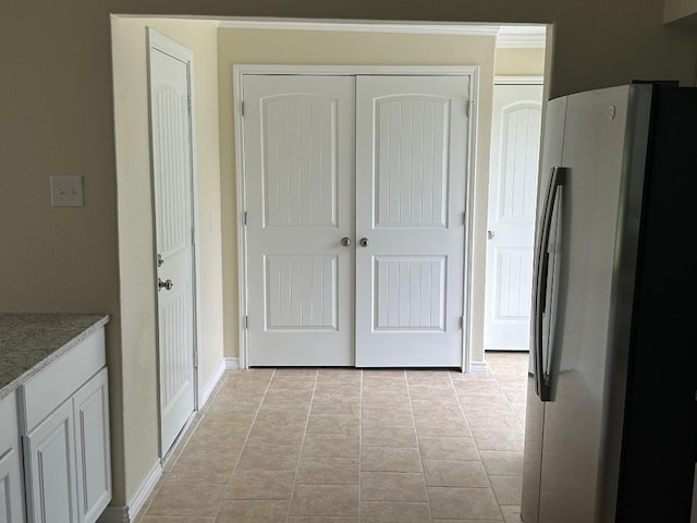 hall featuring light tile floors