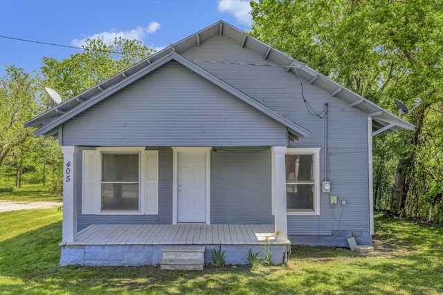 back of property featuring a yard