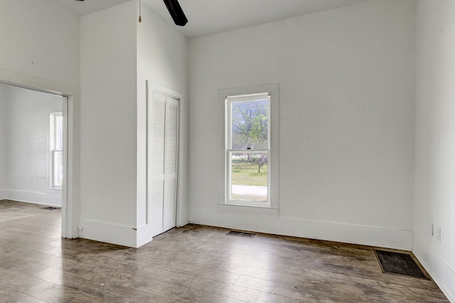 spare room with a wealth of natural light and hardwood / wood-style flooring