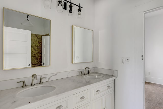 bathroom with wood-type flooring and double vanity