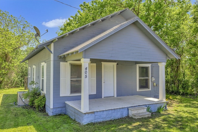 rear view of property with a lawn