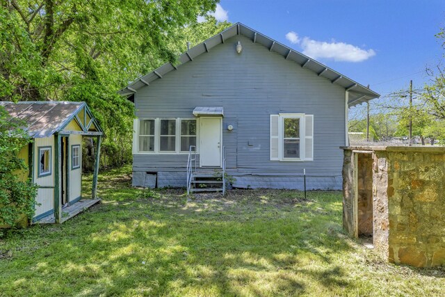 back of property featuring a lawn