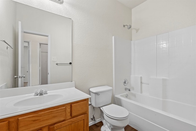 full bathroom with vanity, washtub / shower combination, and toilet